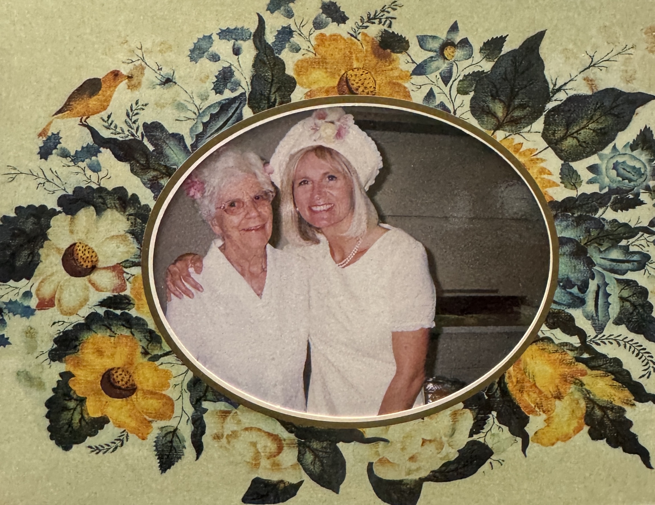 Two smiling women dressed for high tea 