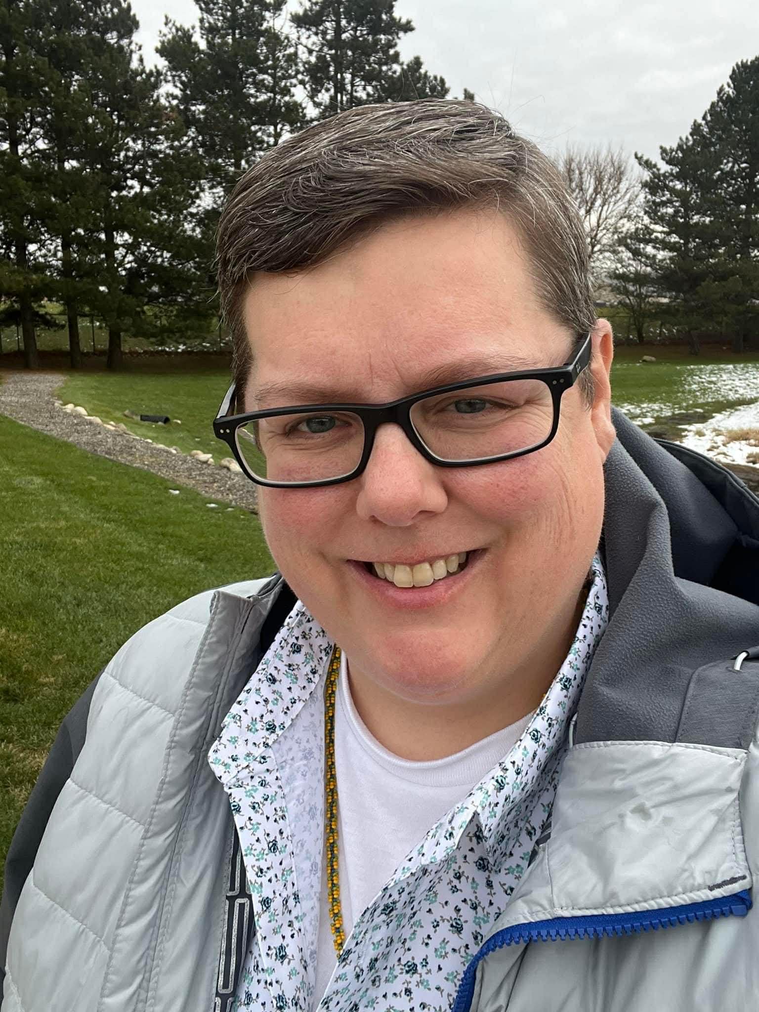 Christina smiling in a field 