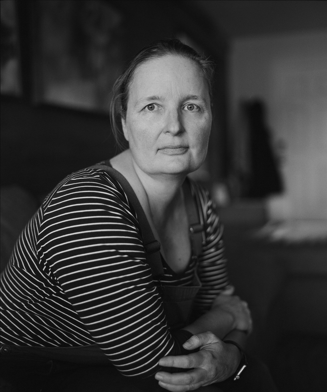 woman in black and white stripes gazing stoically