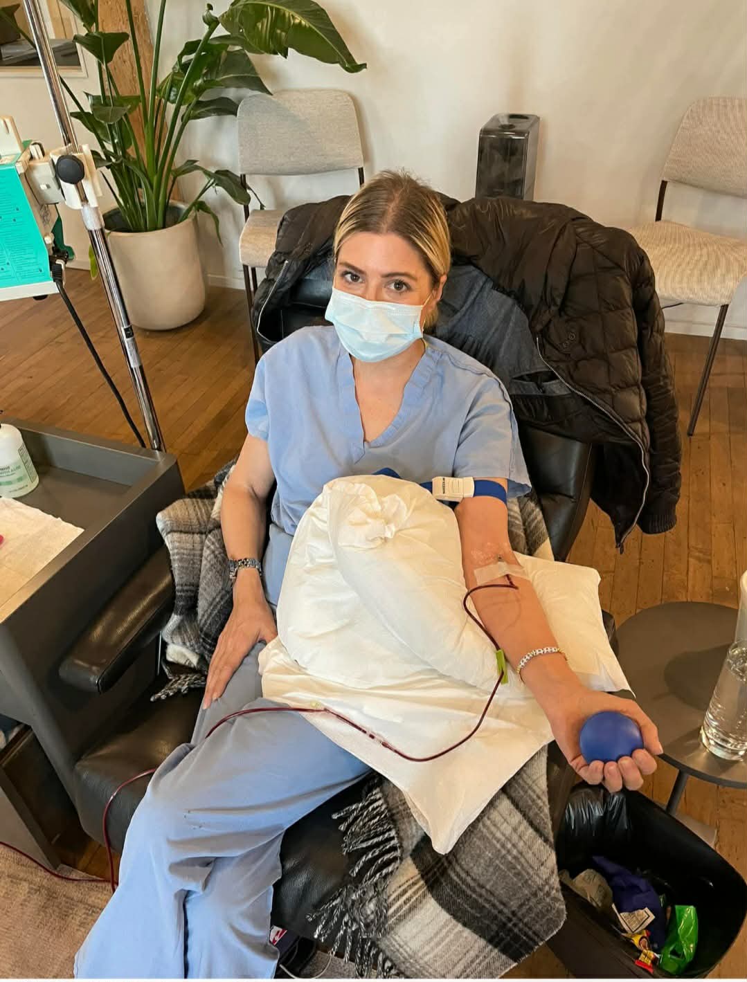 Mary Zack in a mask receiving an infusion 