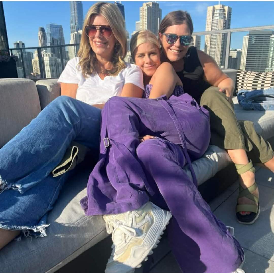Mary Zack with sisters Emily and Betsy on a sunny urban balcony