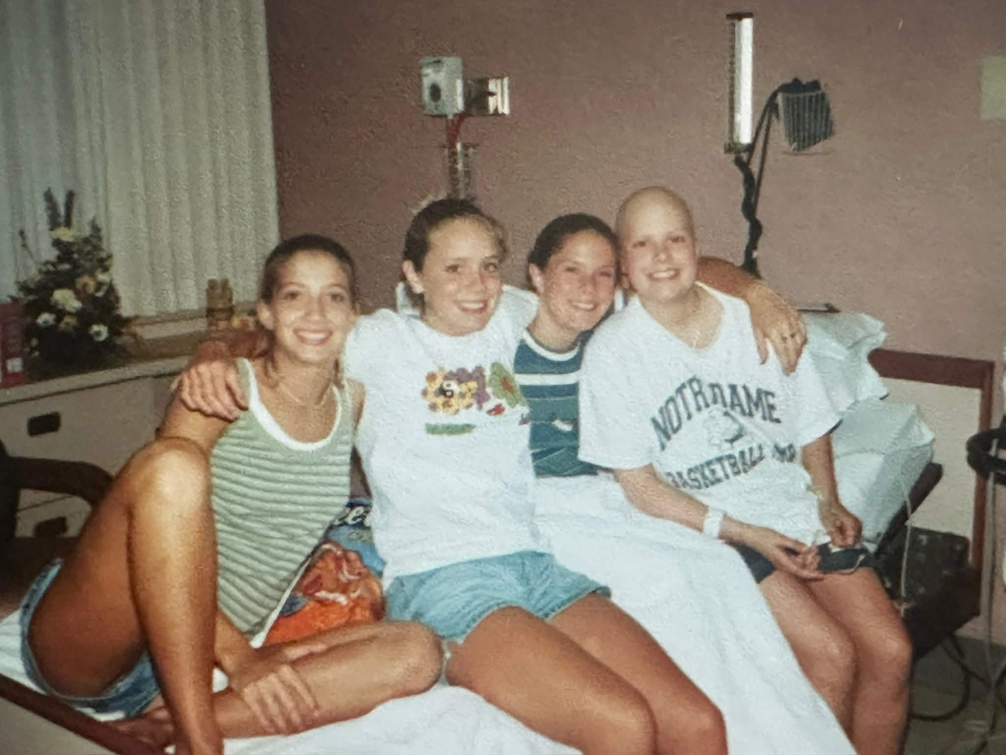 Mary Zack as a teenager on a hospital bed with three other young women