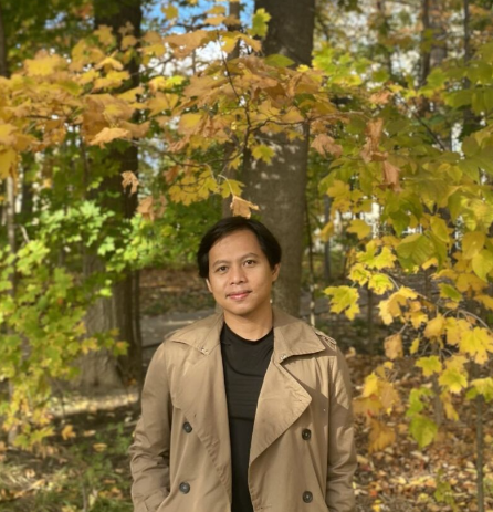 Tri smiling in a forest