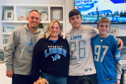 A family and their dogs wearing Detroit Lions gear 