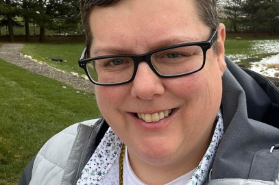 Christina smiling in a field 