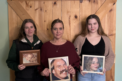 three women holding family photos