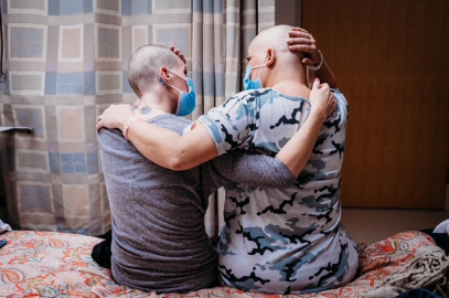 Sarah and Danyel, embracing after shaving in solidarity.