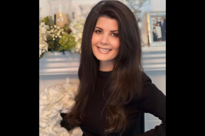 smiling woman in front of mantlepiece