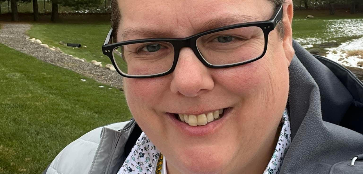 Christina smiling in a field 