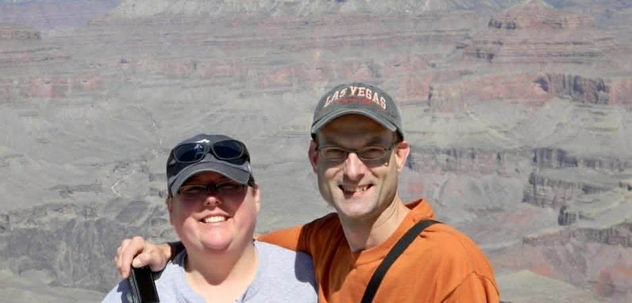 Christina and her brother smiling in front of a canyon