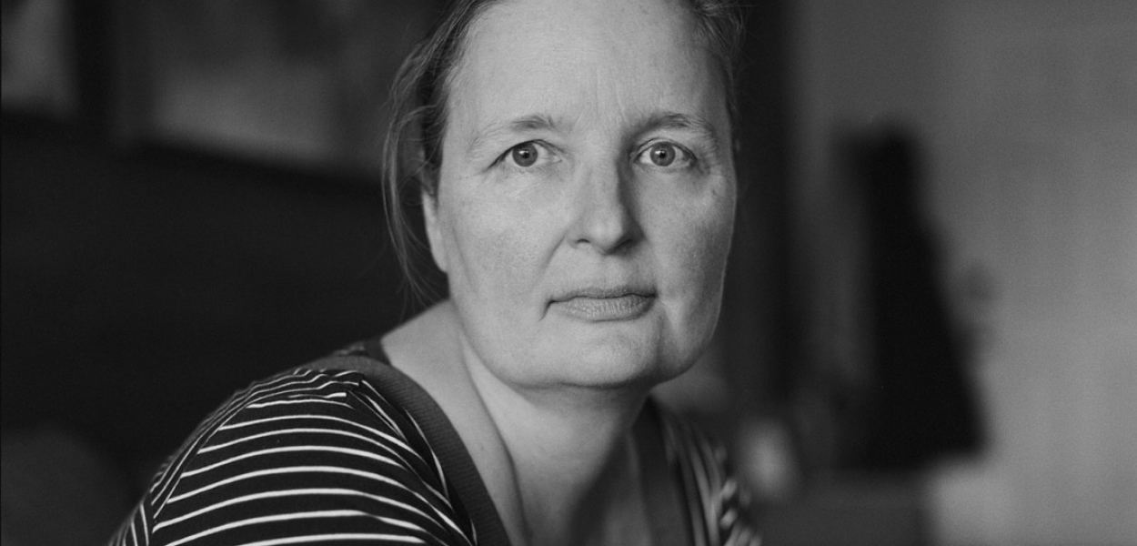 woman in black and white stripes gazing stoically