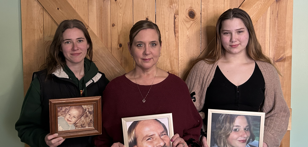 three women holding family photos