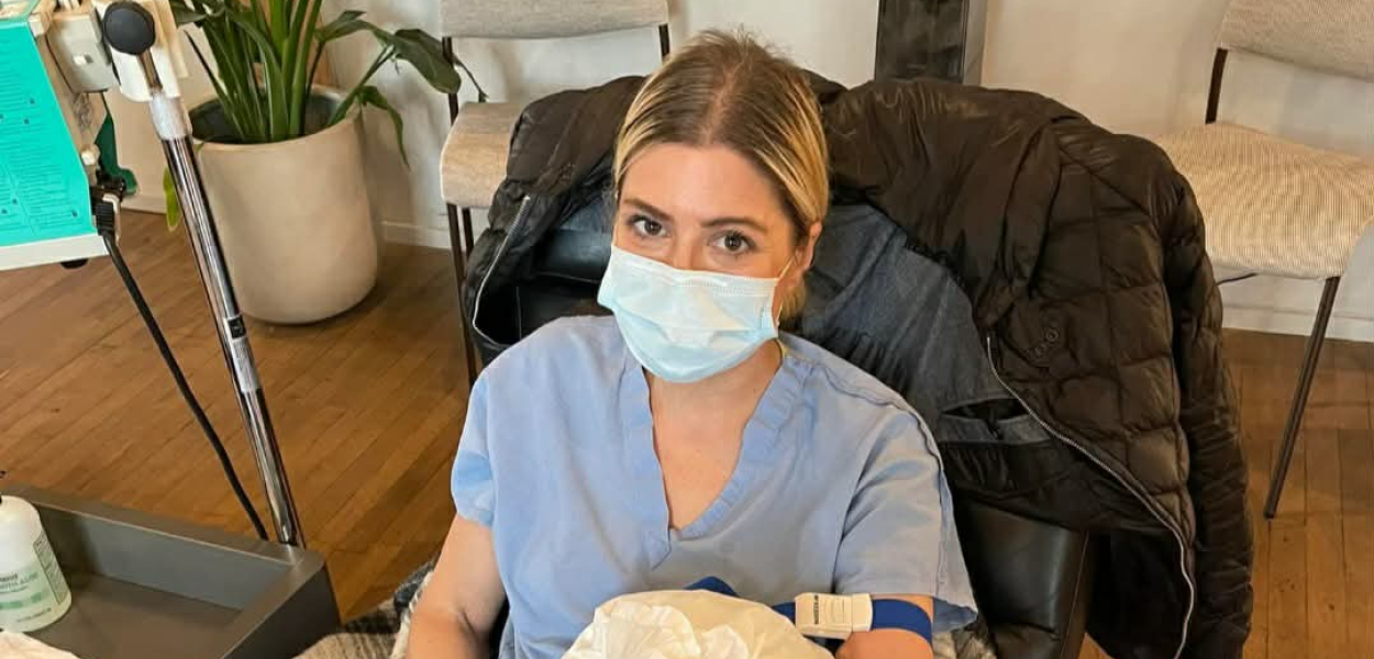 Mary Zack in a mask receiving an infusion 