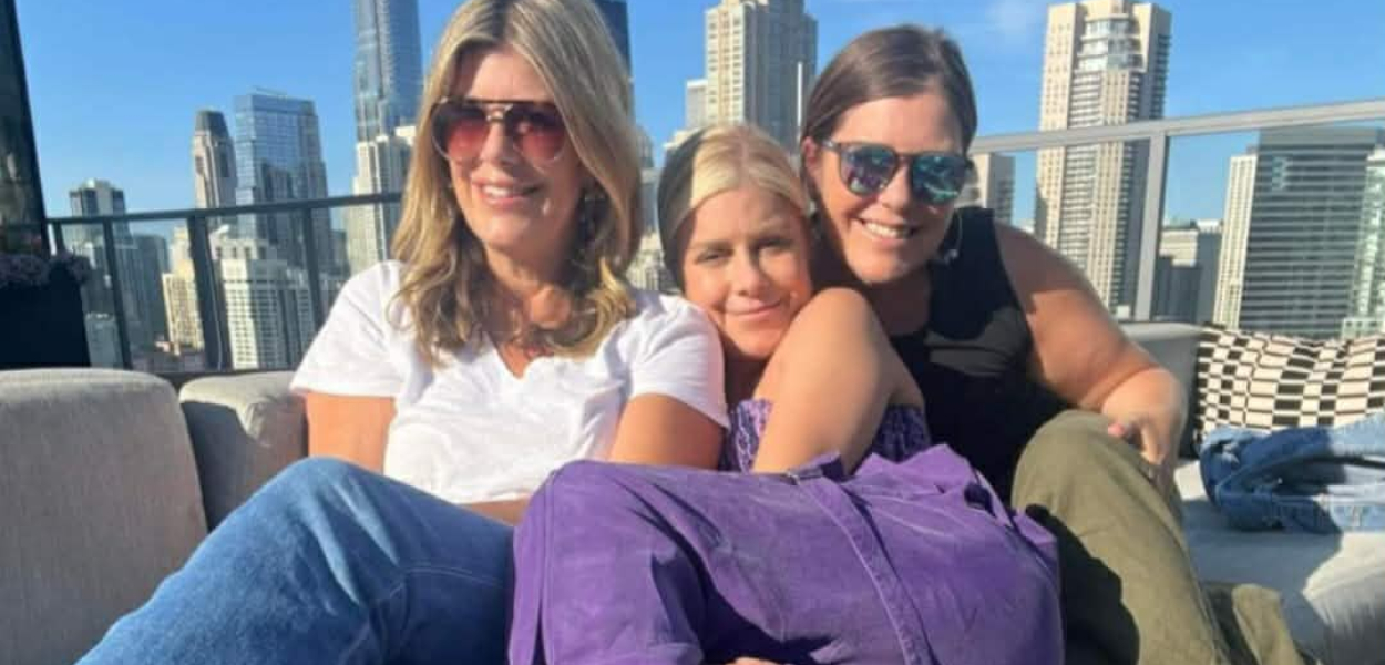 Mary Zack with sisters Emily and Betsy on a sunny urban balcony