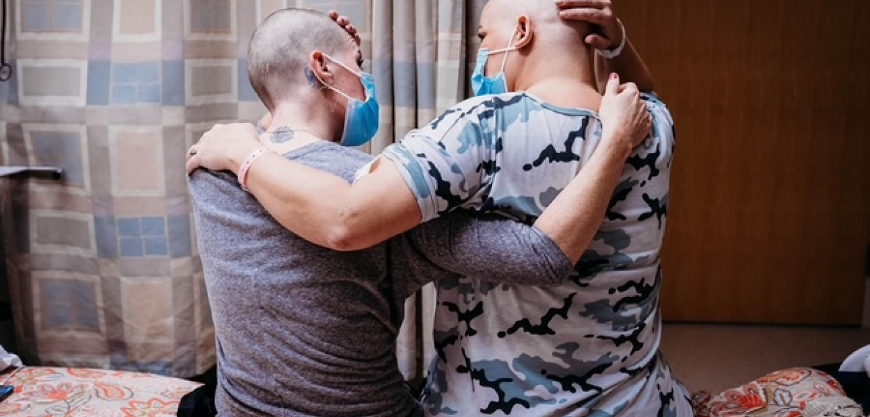 Sarah and Danyel, embracing after shaving in solidarity.