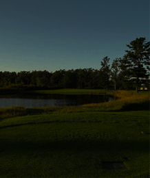 A scenic view of a lake with a forest backdrop