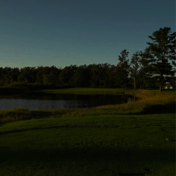 A scenic view of a lake with a forest backdrop
