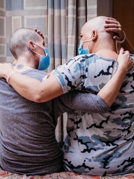 Sarah and Danyel, embracing after shaving in solidarity.