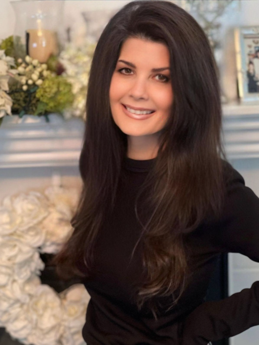 smiling woman in front of mantlepiece