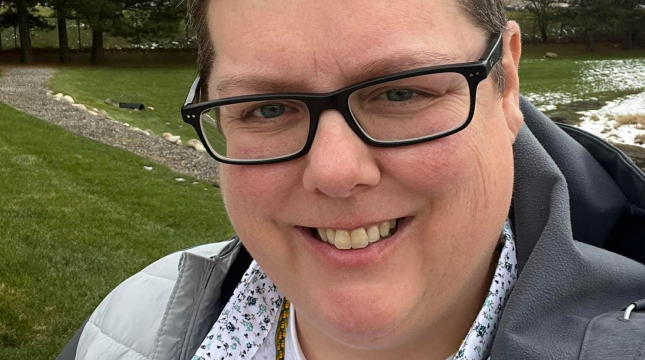 Christina smiling in a field 