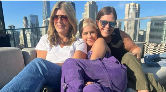 Mary Zack with sisters Emily and Betsy on a sunny urban balcony