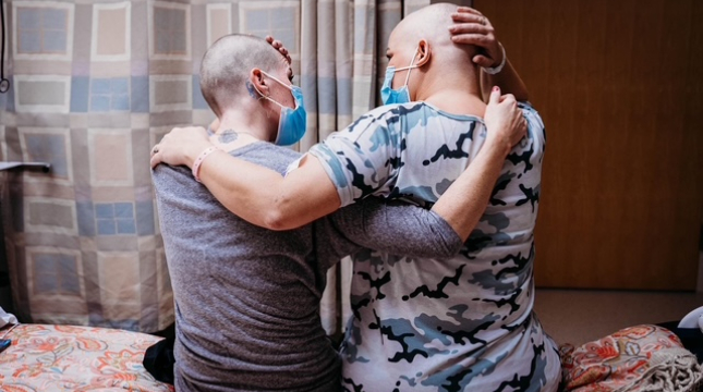 Sarah and Danyel, embracing after shaving in solidarity.
