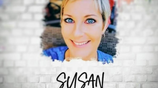 cutout of a smiling woman against a white brick background 