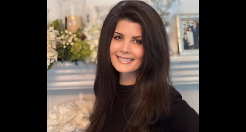 smiling woman in front of mantlepiece